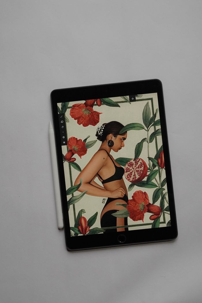 Mastering the First Impression: Your intriguing post title goes here A digital illustration depicting a woman amidst vibrant floral designs on a tablet screen, showcasing modern creativity.