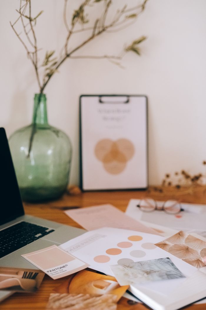 About Artistic desk setup with documents and plant vase, inspiring creativity and organization.